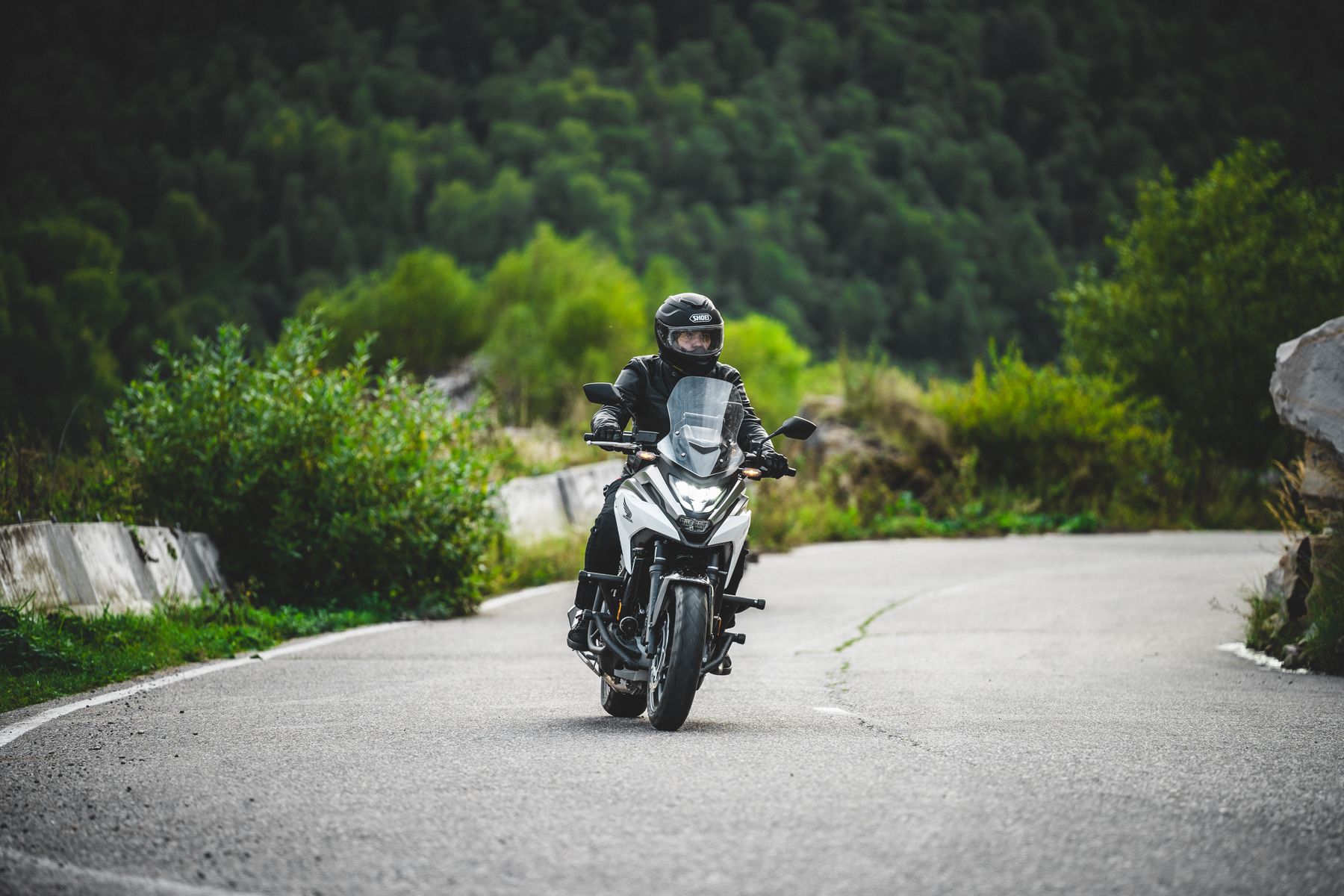 Motorcyclist on a winding coastal road